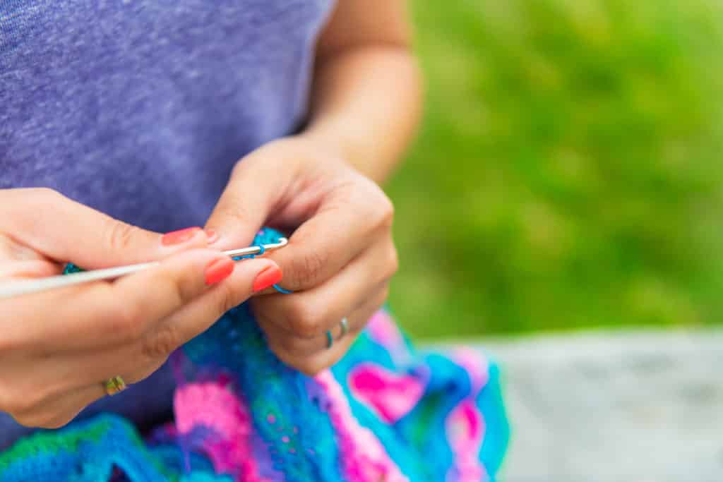 Woman crocheting with crochet thread